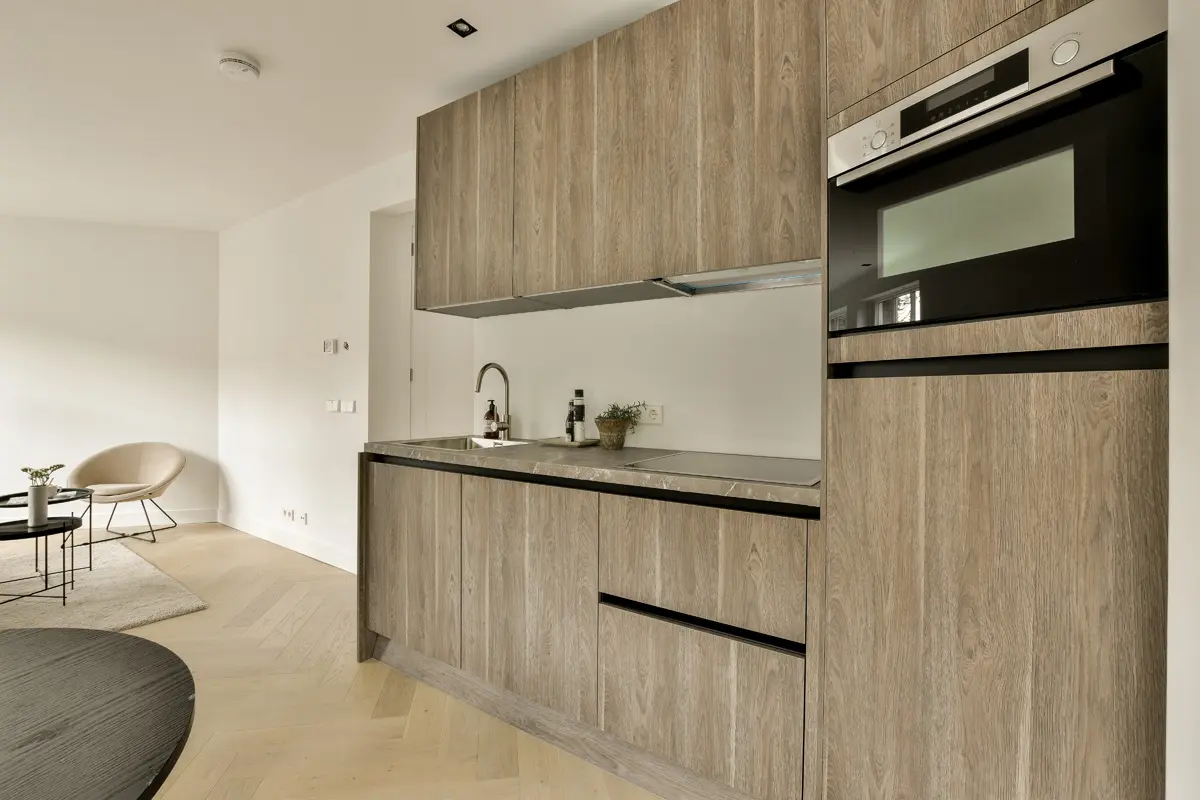 Open-concept casita kitchen — custom wood-grain cabinetry